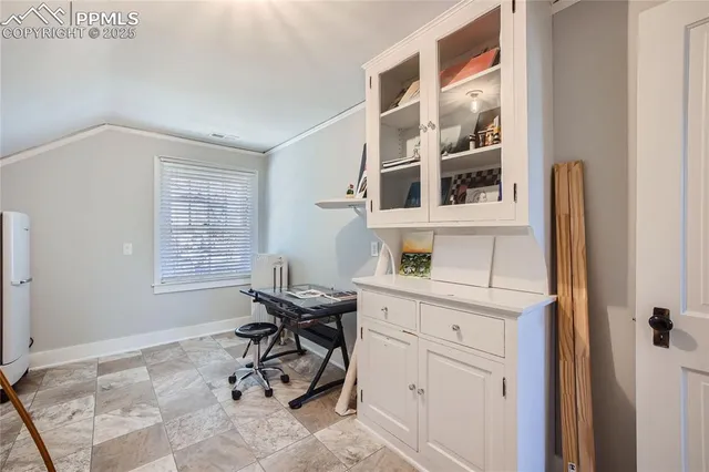 a view of a bedroom with furniture and windows