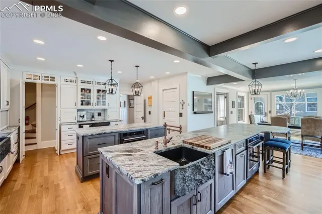 a kitchen with stainless steel appliances granite countertop a kitchen island a stove a table and chairs