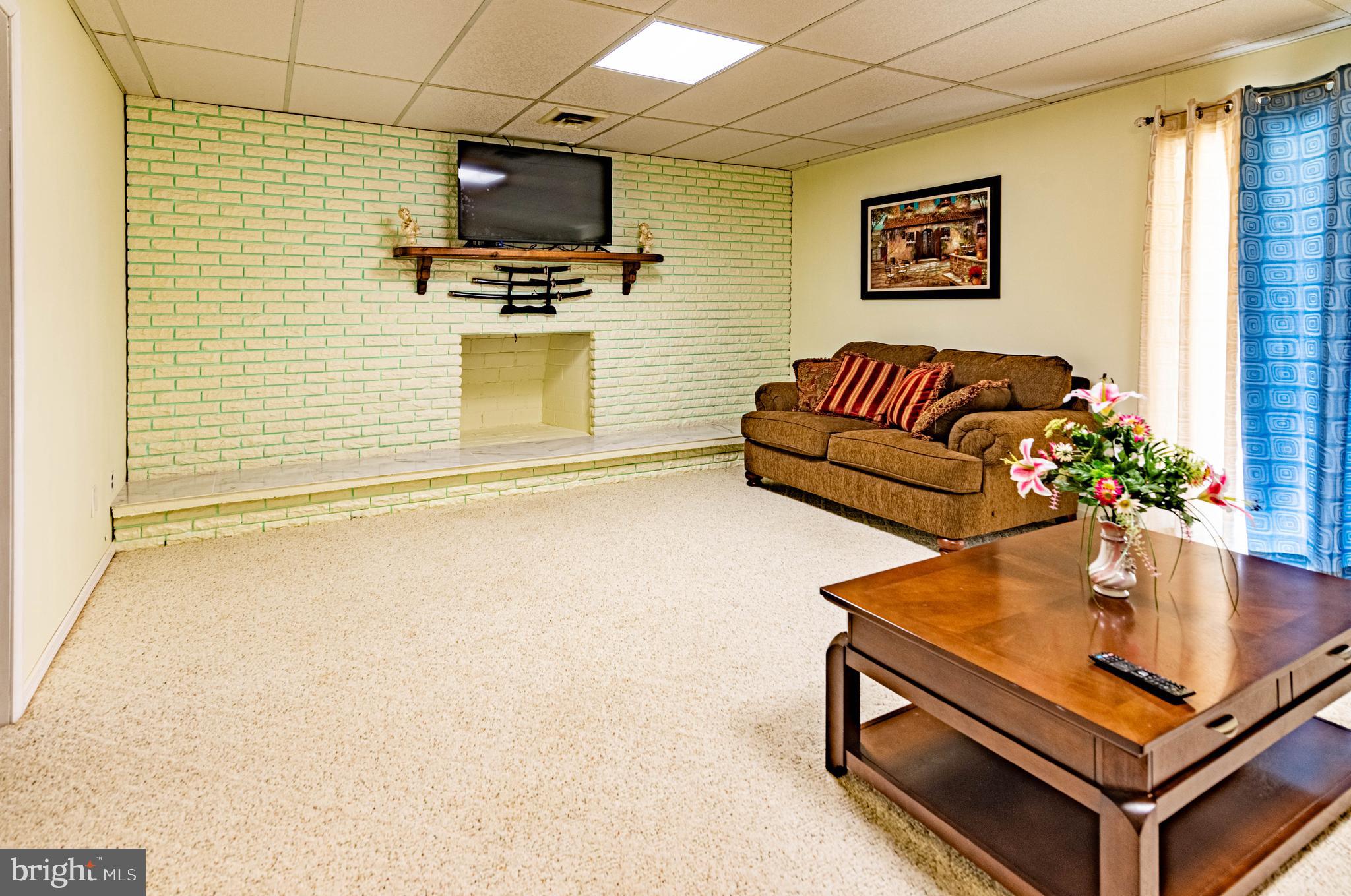 9619 Boyds Turn Road Owings, MD 20736 - Photo 35 of 69 a living room with furniture and a flat screen tv