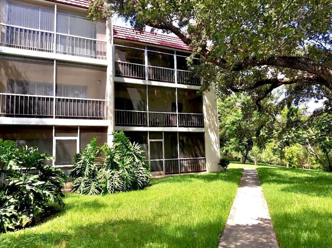610 Northwest 13th Street, Unit 23 Boca Raton, FL 33486 - Photo 4 of 28 a front view of a house with a yard