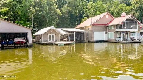 a living room with furniture a fireplace and a chandelier