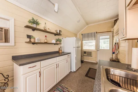 a kitchen with a sink cabinets and window
