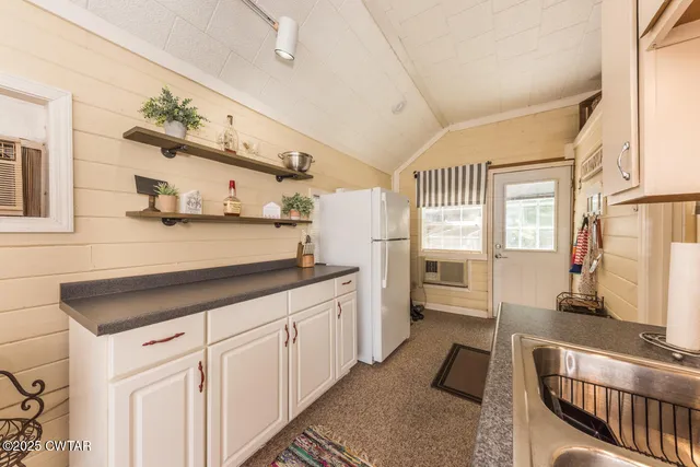 a kitchen with a sink cabinets and window