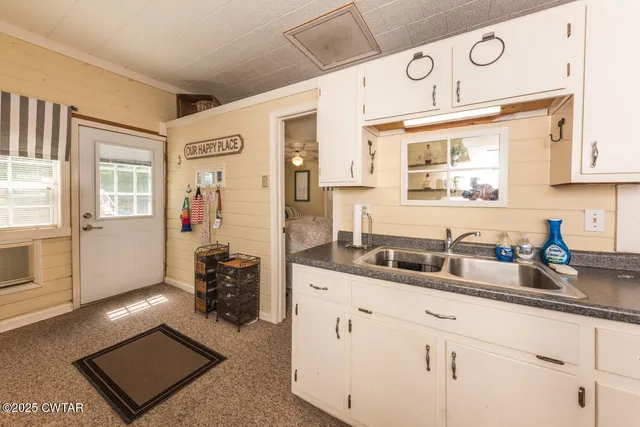 a kitchen with cabinets and wooden floor