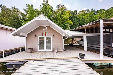 a view of a house with pool and wooden floor