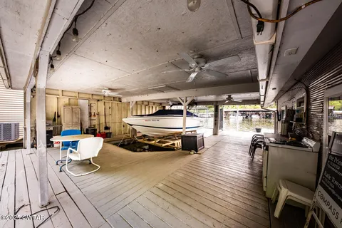 a view of a patio with table and chairs with wooden floor and fence