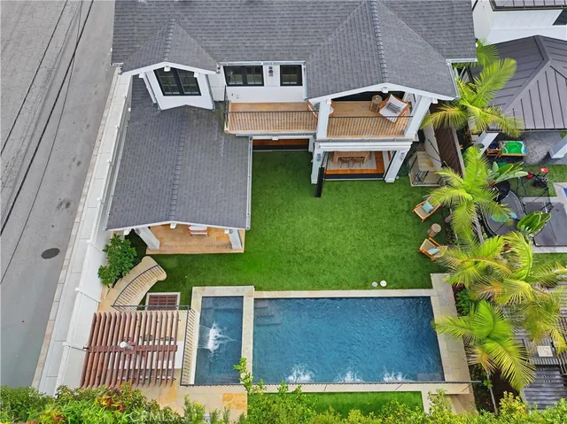 a dining room with wooden floor a chandelier a glass table and chairs