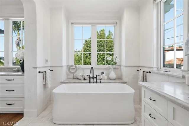 a bathroom with a granite countertop sink a toilet and shower