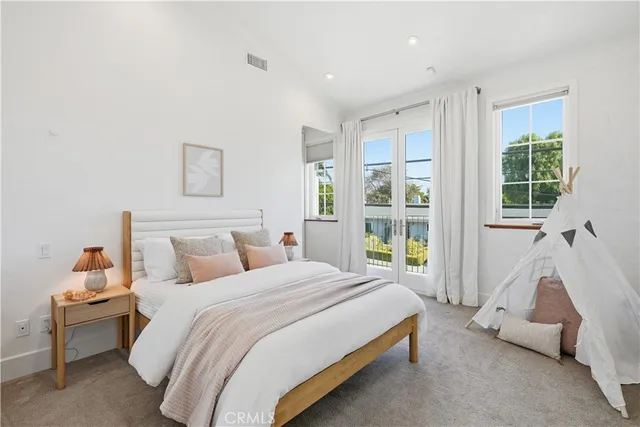 a living room with patio furniture and a potted plant