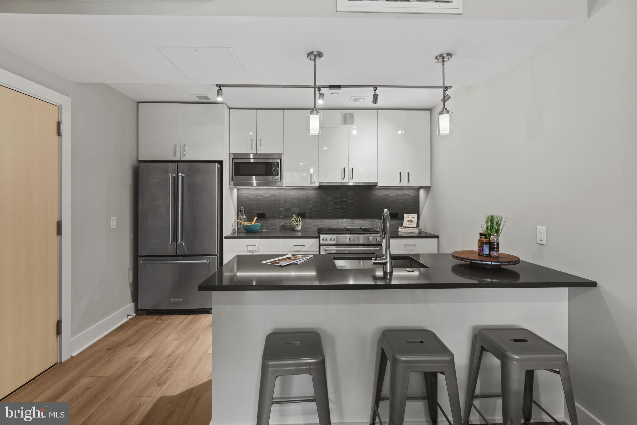 88 V Street Southwest, Unit 710 Washington, DC 20024 - Photo 11 of 44 a kitchen with stainless steel appliances granite countertop a sink and a refrigerator