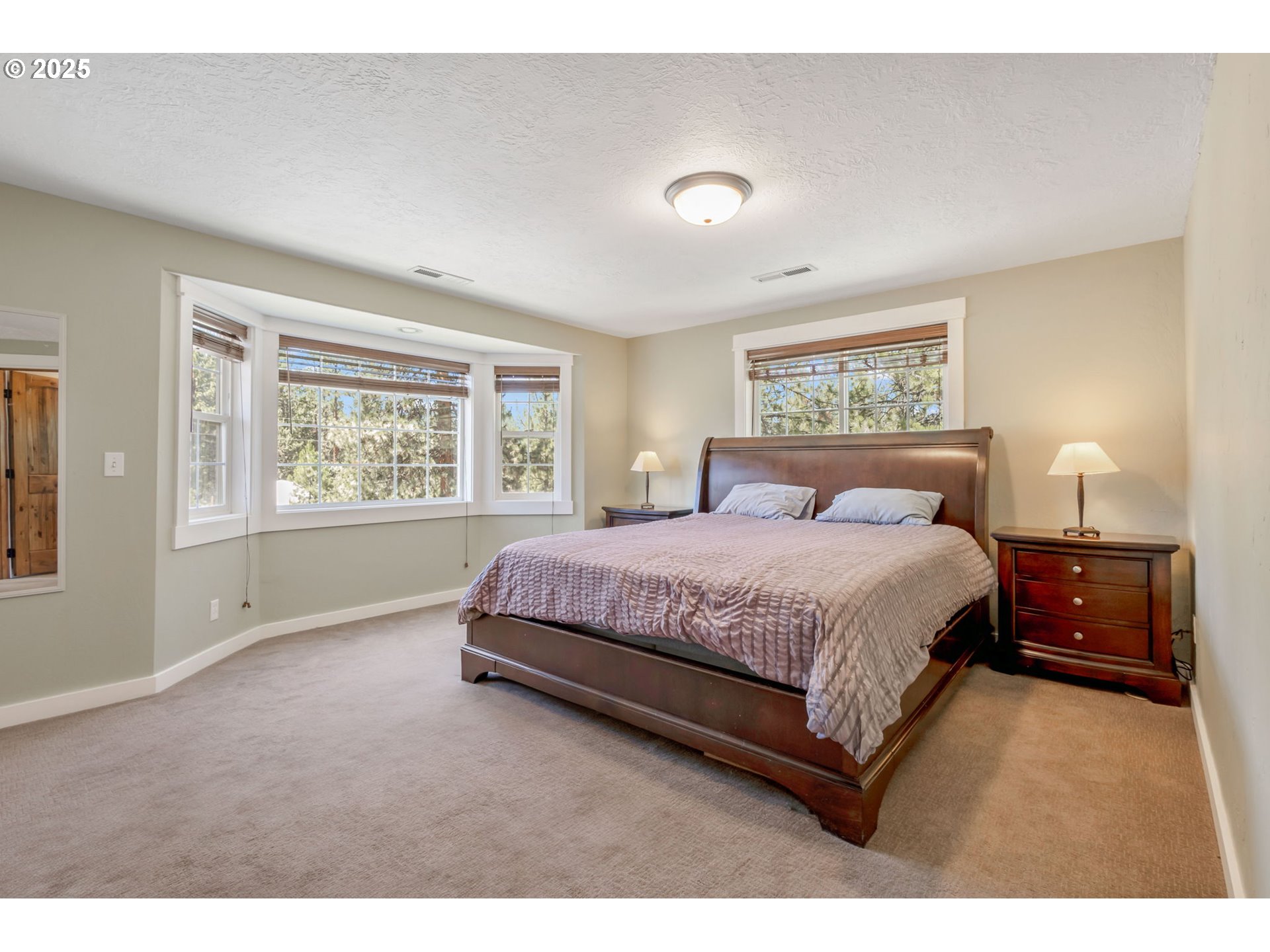 19723 Buck Canyon Road Bend, OR 97702 - Photo 16 of 48 a spacious bedroom with a bed and a window
