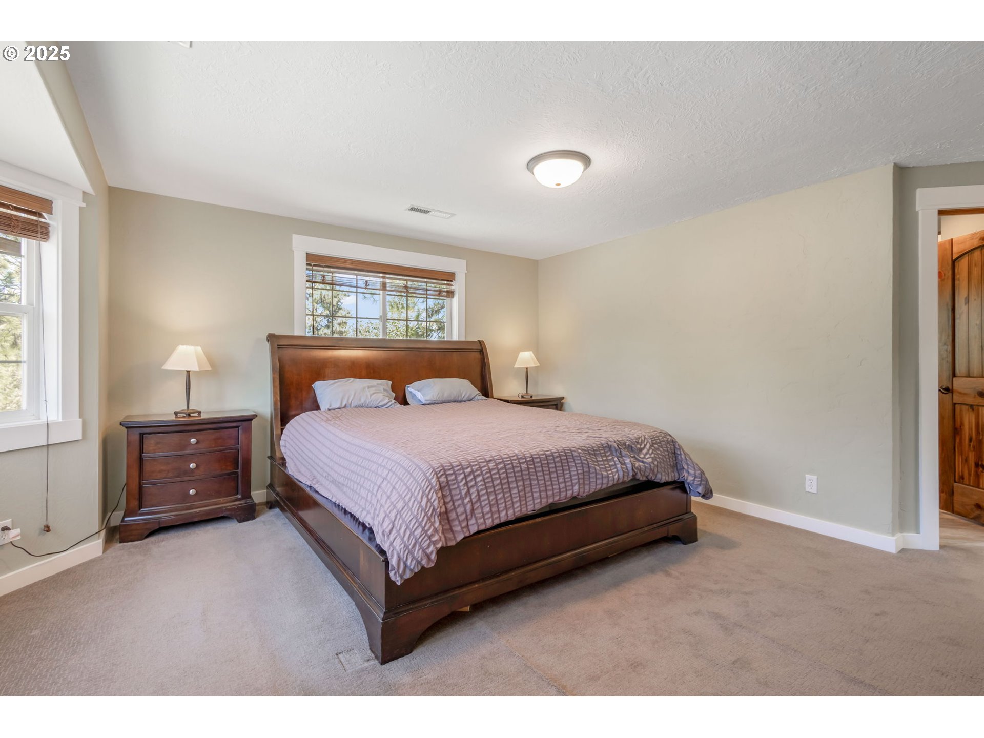 19723 Buck Canyon Road Bend, OR 97702 - Photo 17 of 48 a bedroom with a bed and a night stand