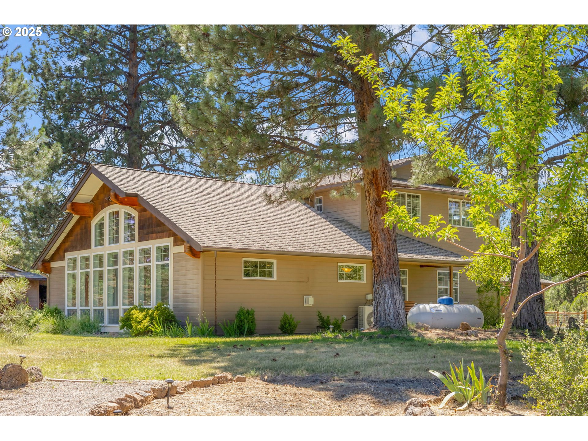 19723 Buck Canyon Road Bend, OR 97702 - Photo 2 of 48 a front view of a house with a yard