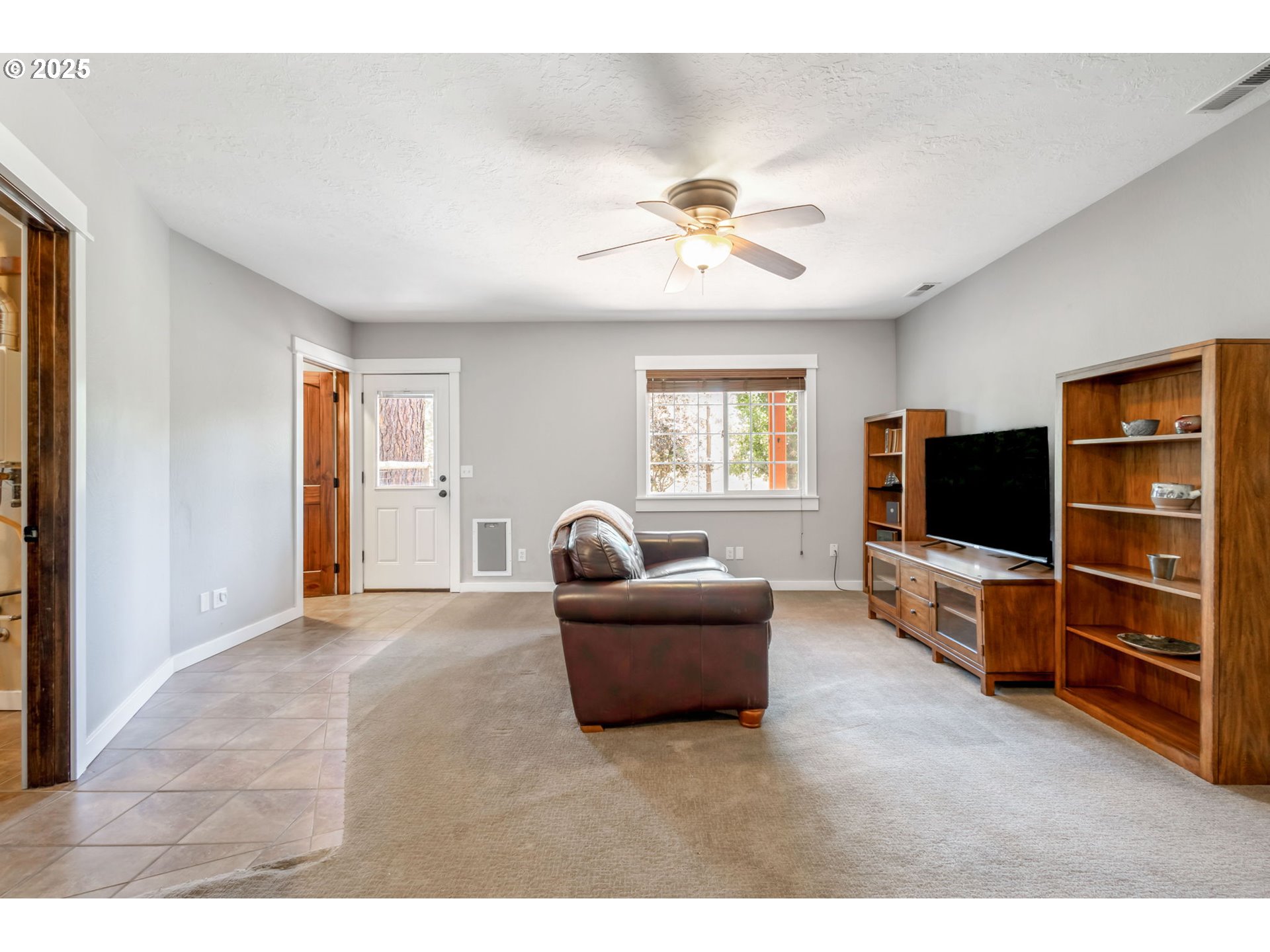 19723 Buck Canyon Road Bend, OR 97702 - Photo 25 of 48 a living room with furniture and a flat screen tv