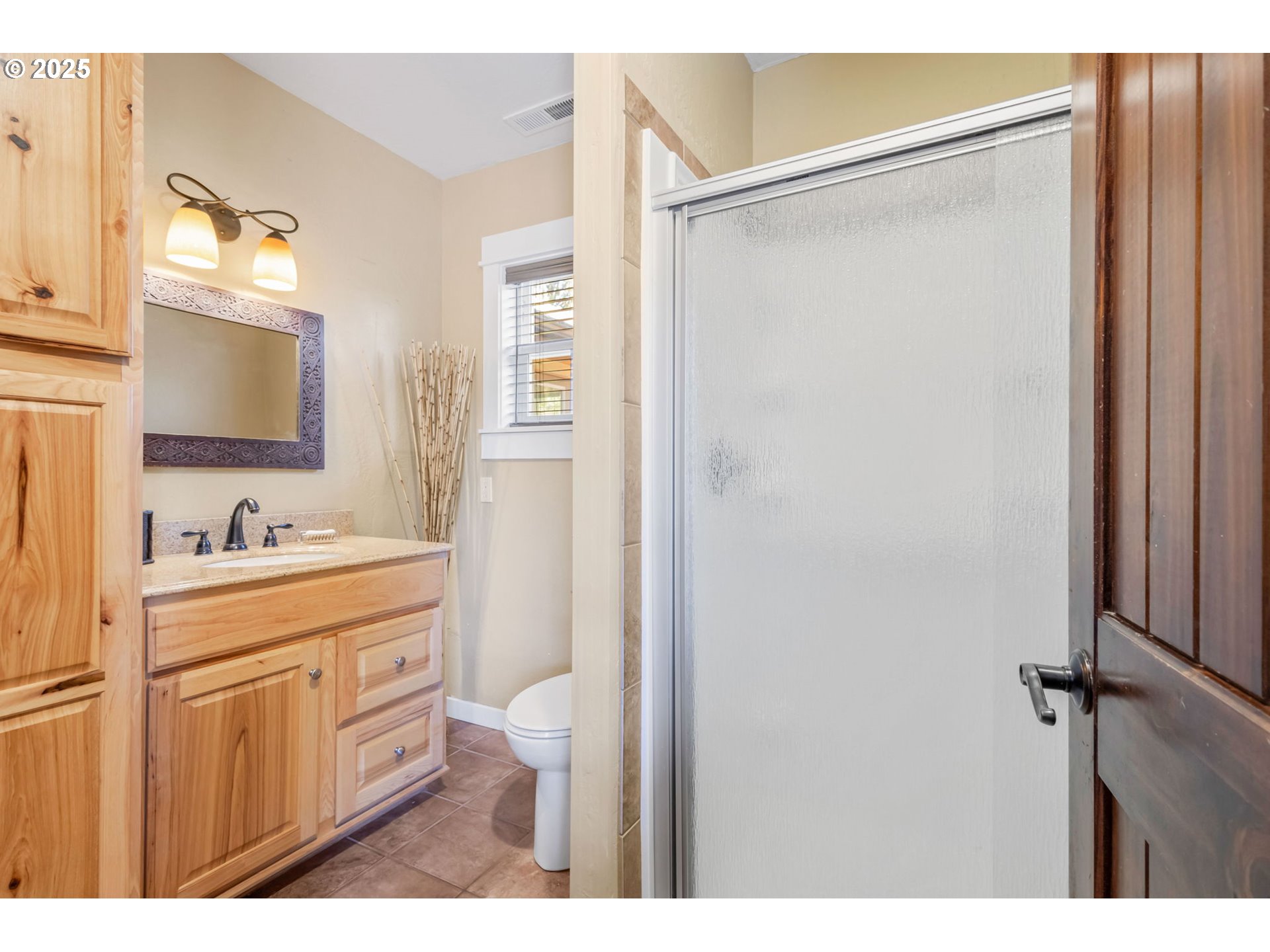 19723 Buck Canyon Road Bend, OR 97702 - Photo 26 of 48 a bathroom with a granite countertop sink mirror and a toilet