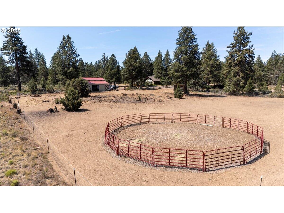 19723 Buck Canyon Road Bend, OR 97702 - Photo 42 of 48 a view of swimming pool with outdoor seating and trees in the background