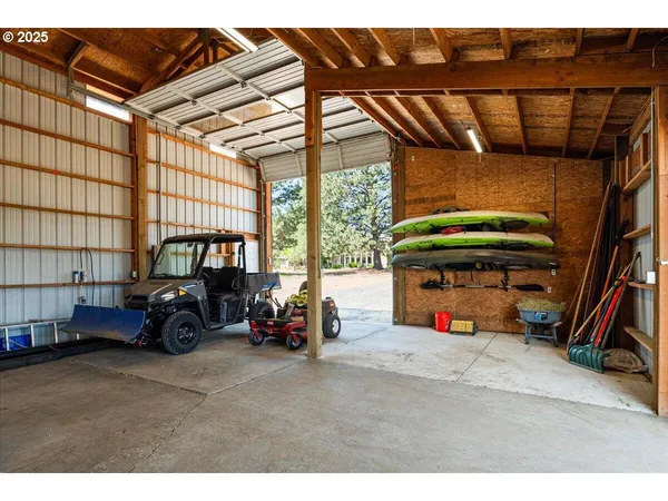 a view of garage with a car and car parked