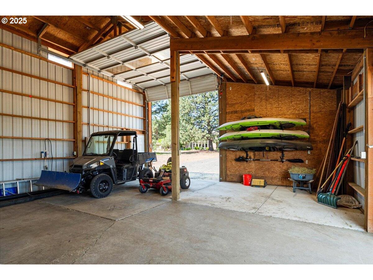 19723 Buck Canyon Road Bend, OR 97702 - Photo 46 of 48 a view of garage with a car and car parked