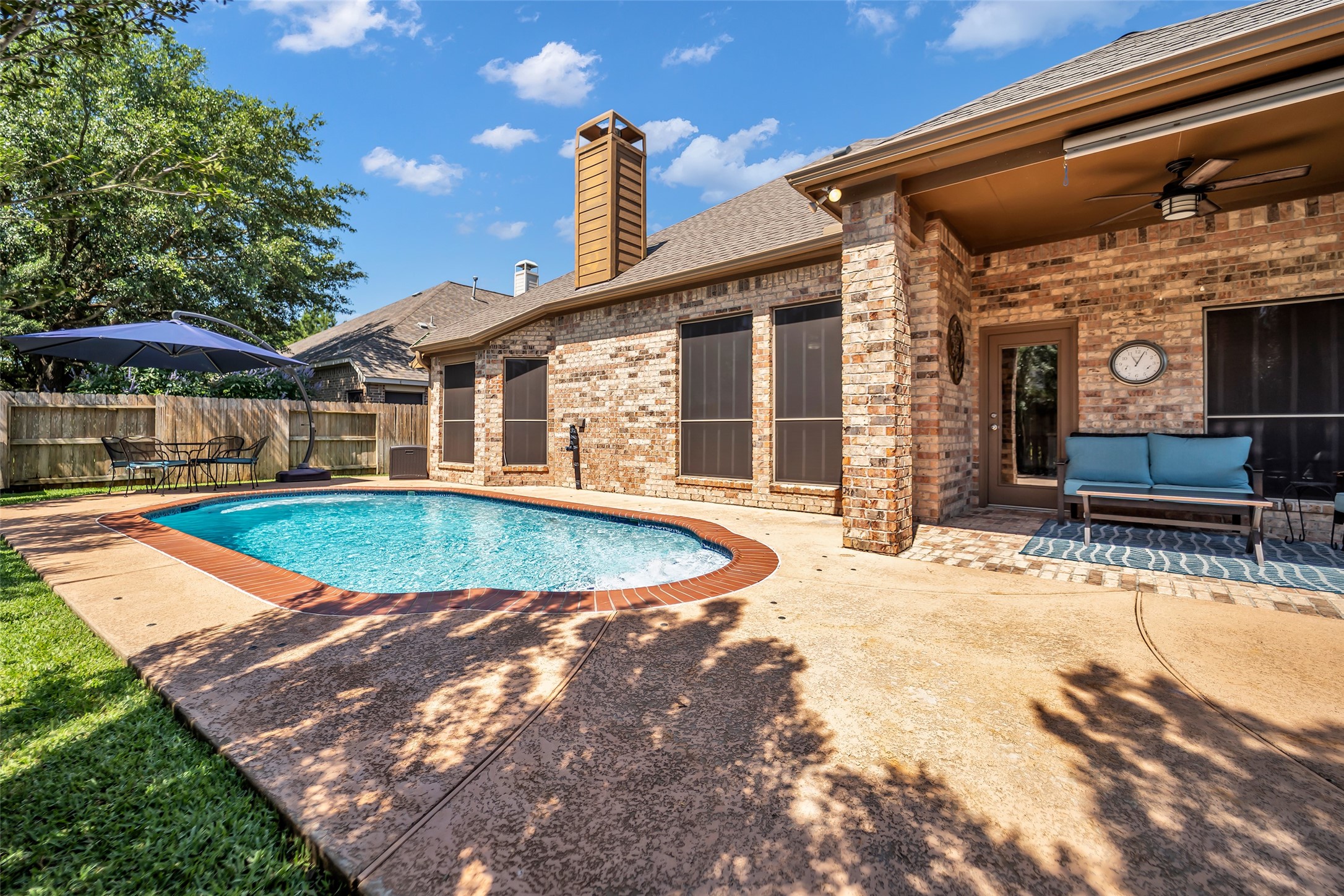 12006 Bayou Junction Road Cypress, TX 77433 - Photo 27 of 38 Nice size heated in ground pool, plus some green space, and space for entertaining.