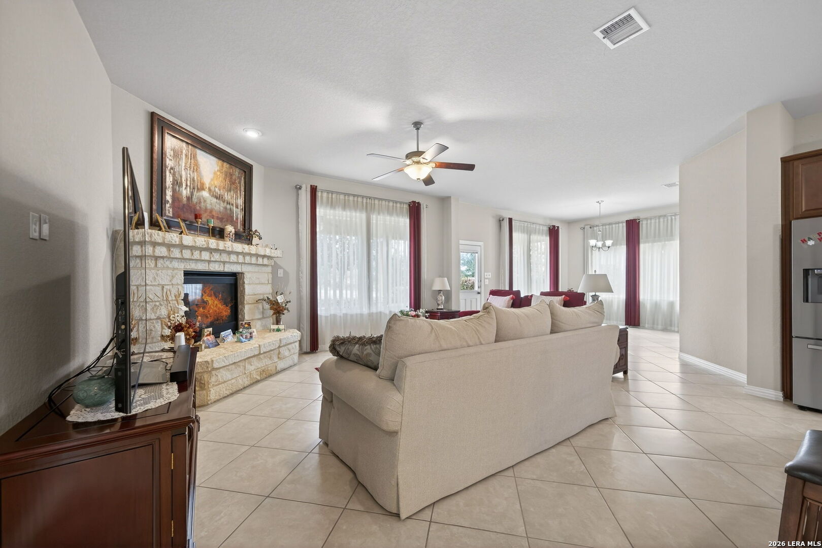 9108 Trail Stem Schertz, TX 78154 - Photo 11 of 26 a living room with furniture a fireplace and a flat screen tv