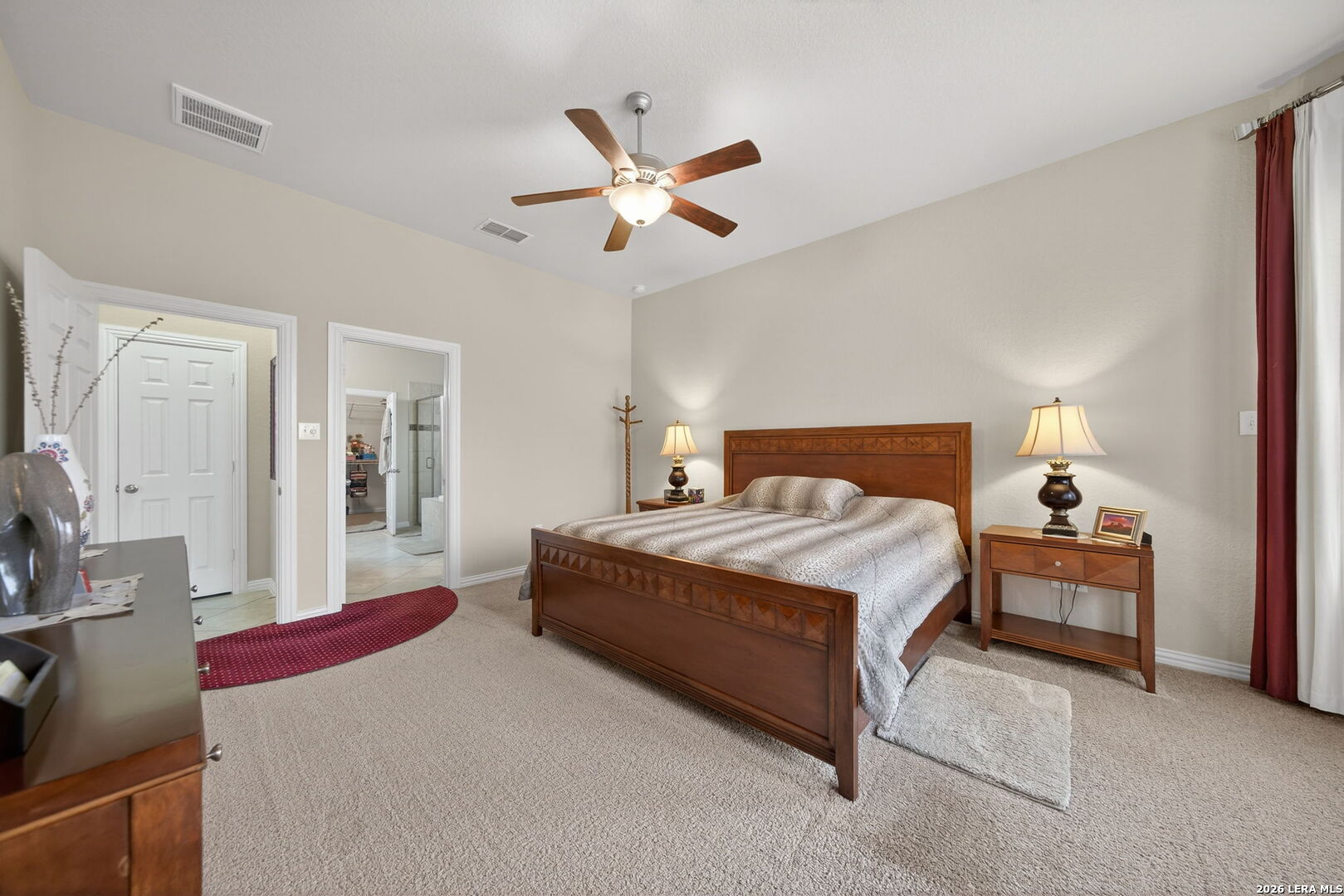 9108 Trail Stem Schertz, TX 78154 - Photo 16 of 26 a bedroom with a bed and a chandelier