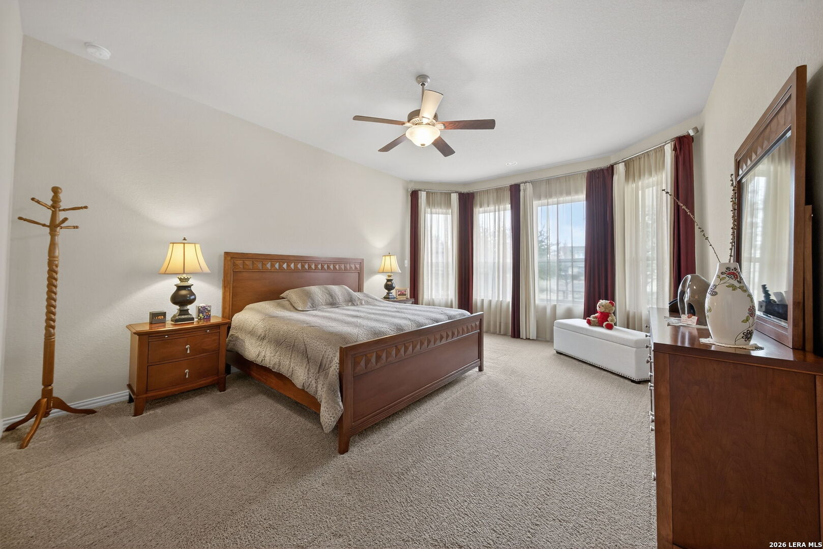 9108 Trail Stem Schertz, TX 78154 - Photo 17 of 26 a spacious bedroom with a bed couch and a large window