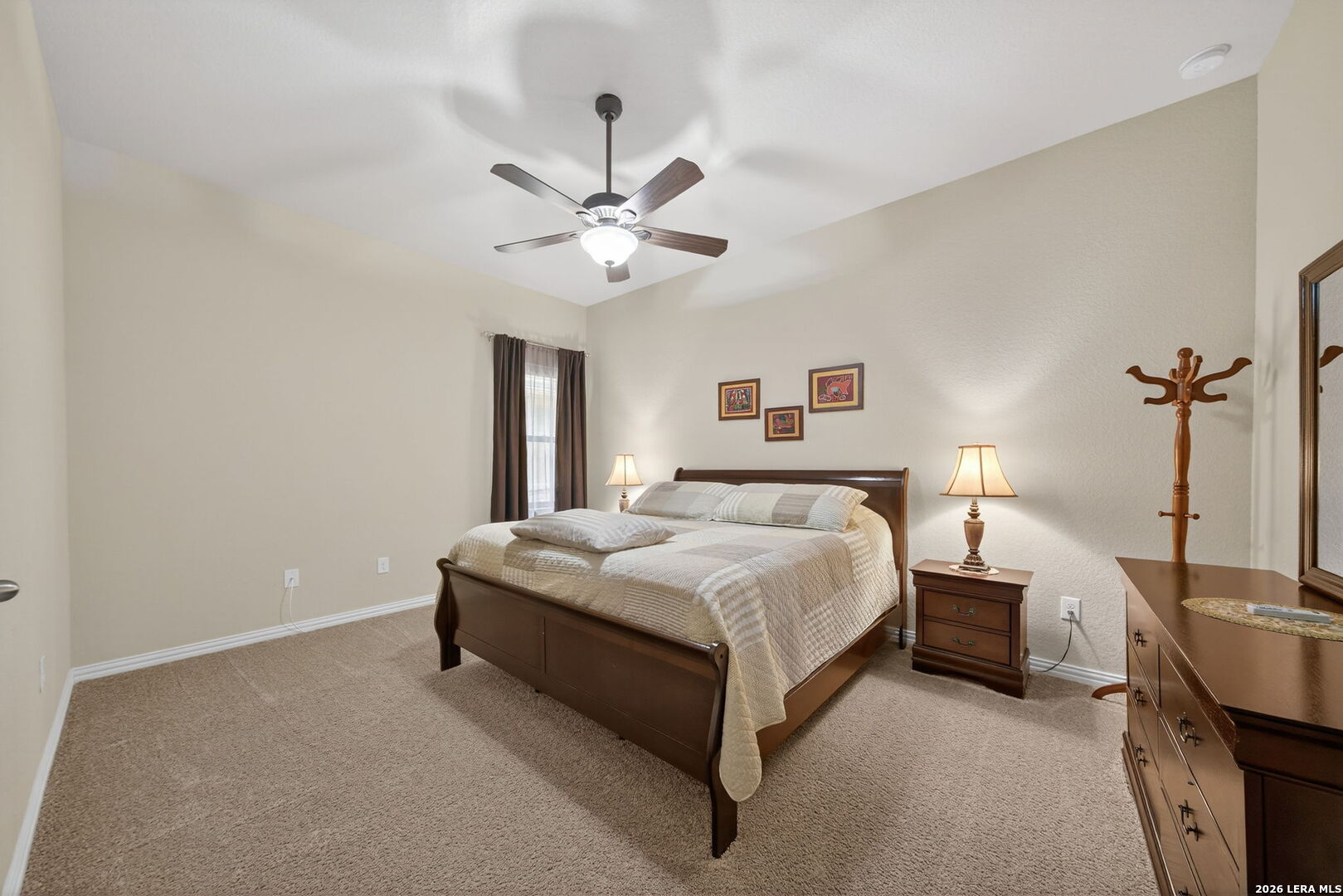 9108 Trail Stem Schertz, TX 78154 - Photo 20 of 26 a spacious bedroom with a bed and a chandelier