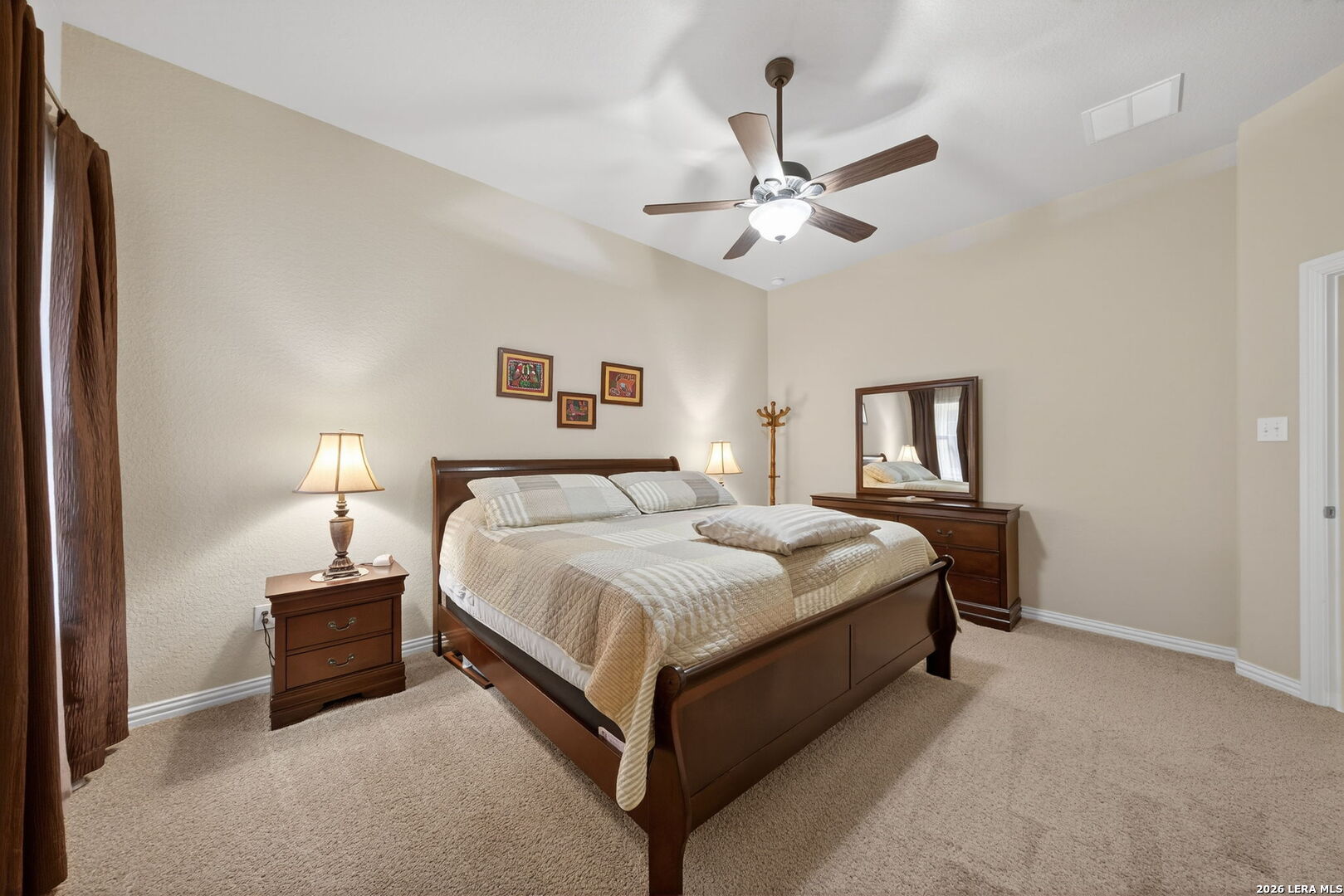 9108 Trail Stem Schertz, TX 78154 - Photo 21 of 26 a spacious bedroom with a bed and a chandelier