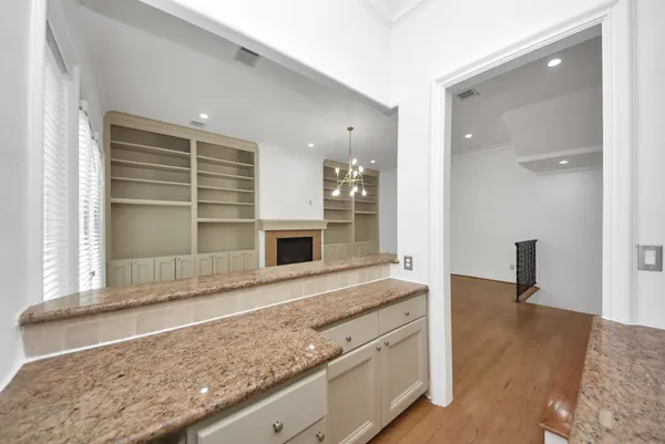 a view of living room with granite countertop cabinets and fireplace