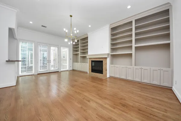 a view of an empty room with a window and fireplace