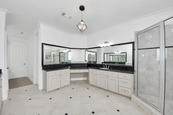a kitchen with white cabinets and white appliances