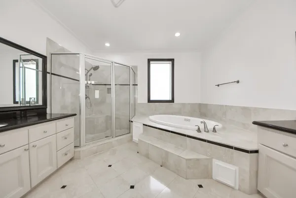 a bathroom with a granite countertop sink a toilet a mirror and shower