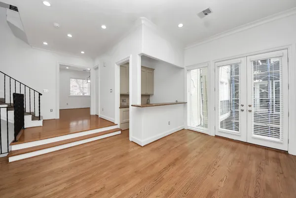 a view of empty room with wooden floor and fireplace
