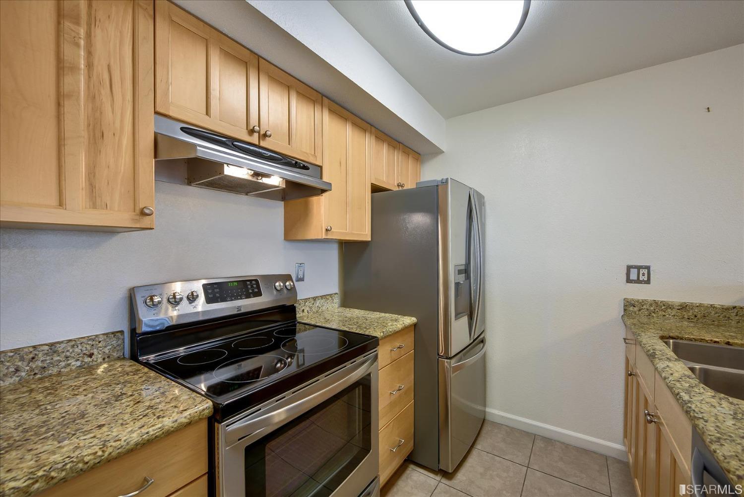 466 Crescent Street, Unit 310 Oakland, CA 94610 - Photo 12 of 24 a kitchen with a stove and a refrigerator