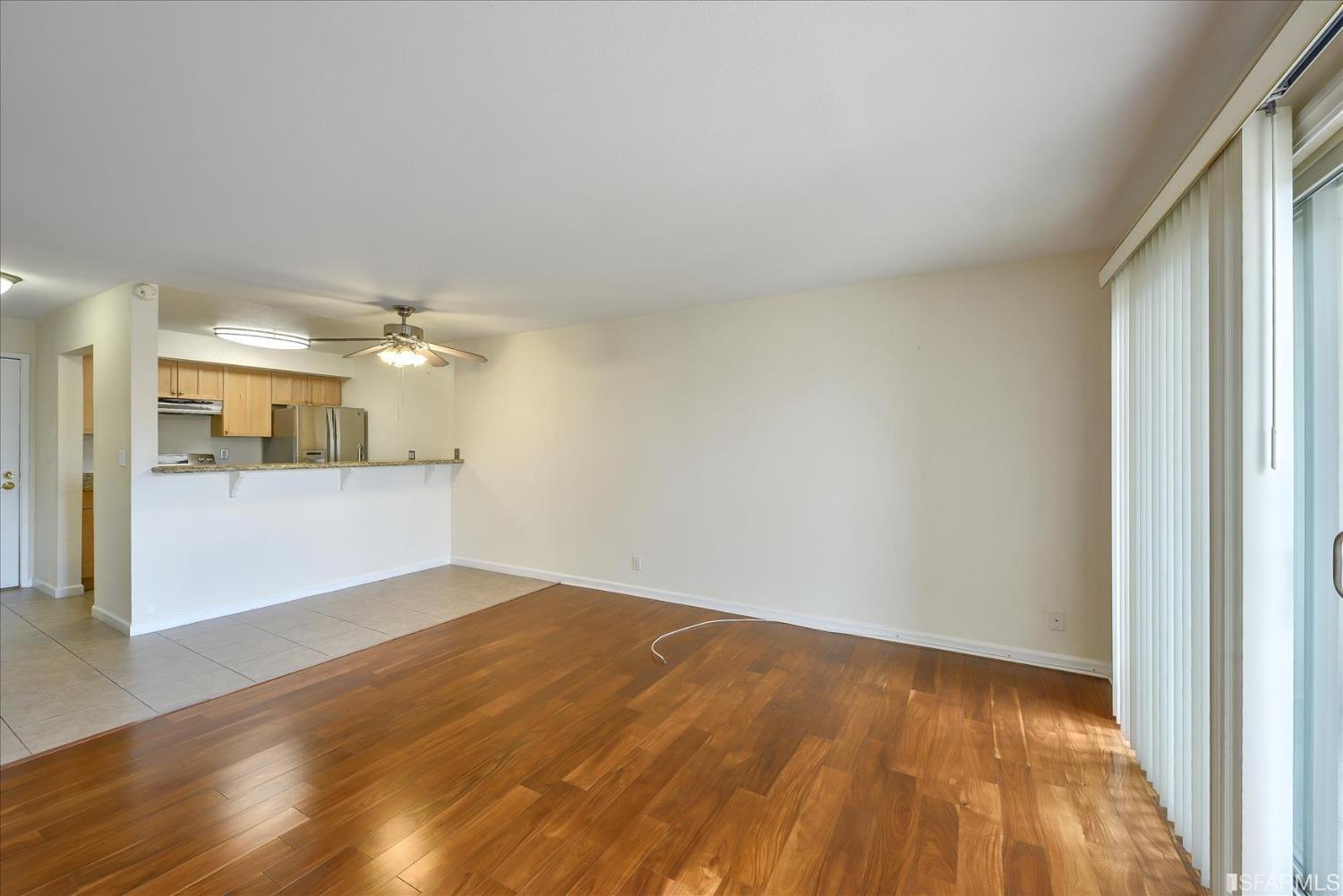 466 Crescent Street, Unit 310 Oakland, CA 94610 - Photo 6 of 24 a view of a room with wooden floor and a window