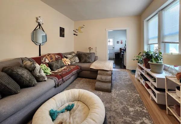 a living room with furniture and a chandelier