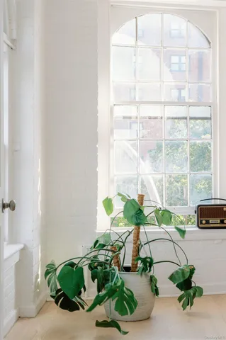 a vase of flowers sitting on a floor
