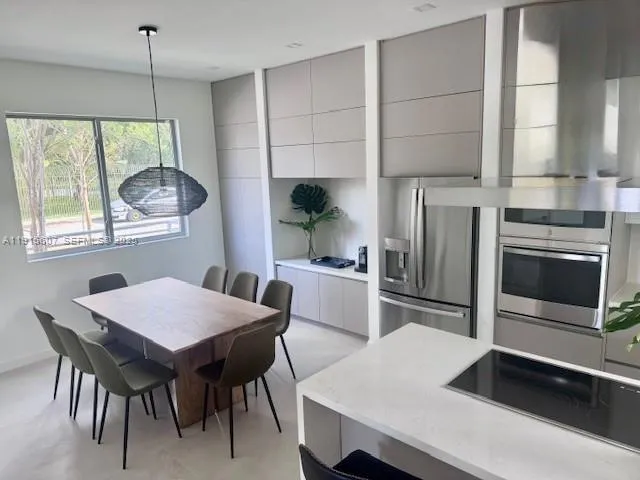 a kitchen with a table chairs and microwave