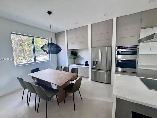 a kitchen with a table and chairs in it