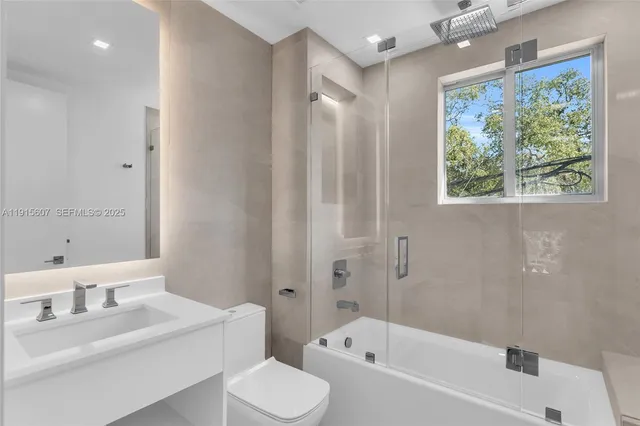 a bathroom with a window sink and mirror