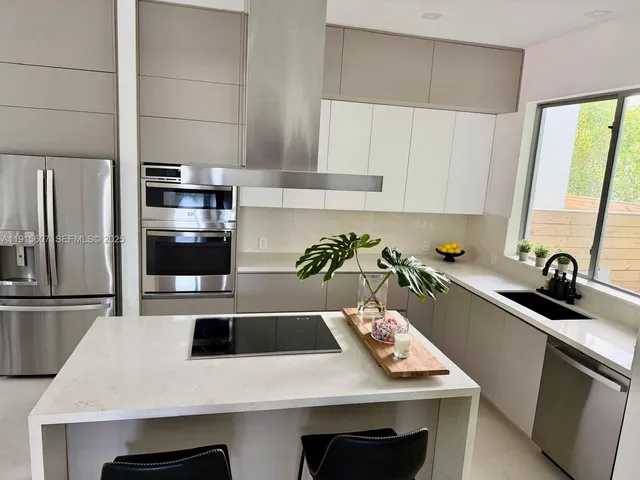 a kitchen with a sink a microwave and cabinets