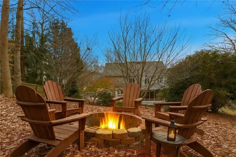 a view of a chairs and tables in the back yard of the house