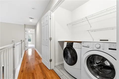 a view of a hallway with washer and dryer