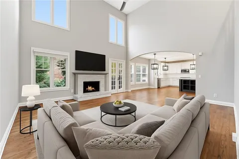 a living room with furniture a fireplace and a flat screen tv