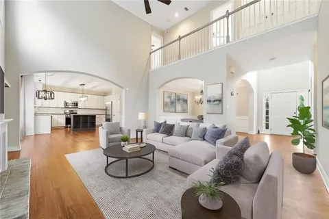 a living room with furniture and a chandelier