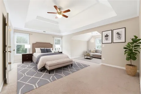 a bedroom with a bed a couch and a potted plant