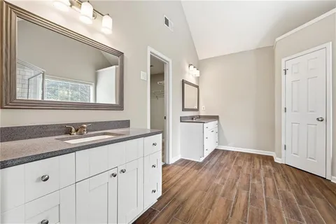 a view of a kitchen with sink and dishwasher with wooden floor