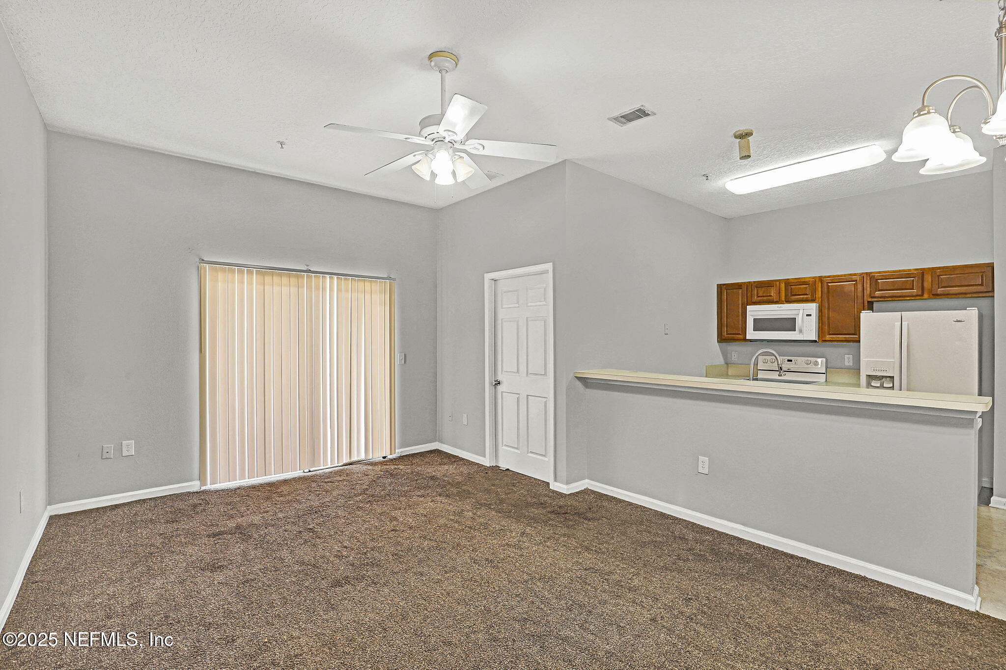 7920 Merrill Road, Unit 305 Jacksonville, FL 32277 - Photo 3 of 12 a view of a bedroom with closet and fan
