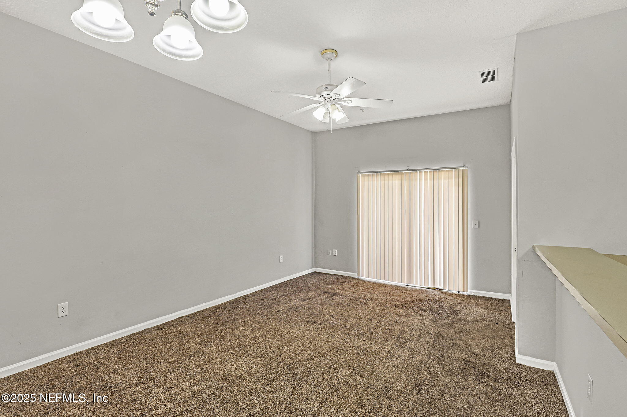 7920 Merrill Road, Unit 305 Jacksonville, FL 32277 - Photo 5 of 12 wooden floor in an empty room with a window