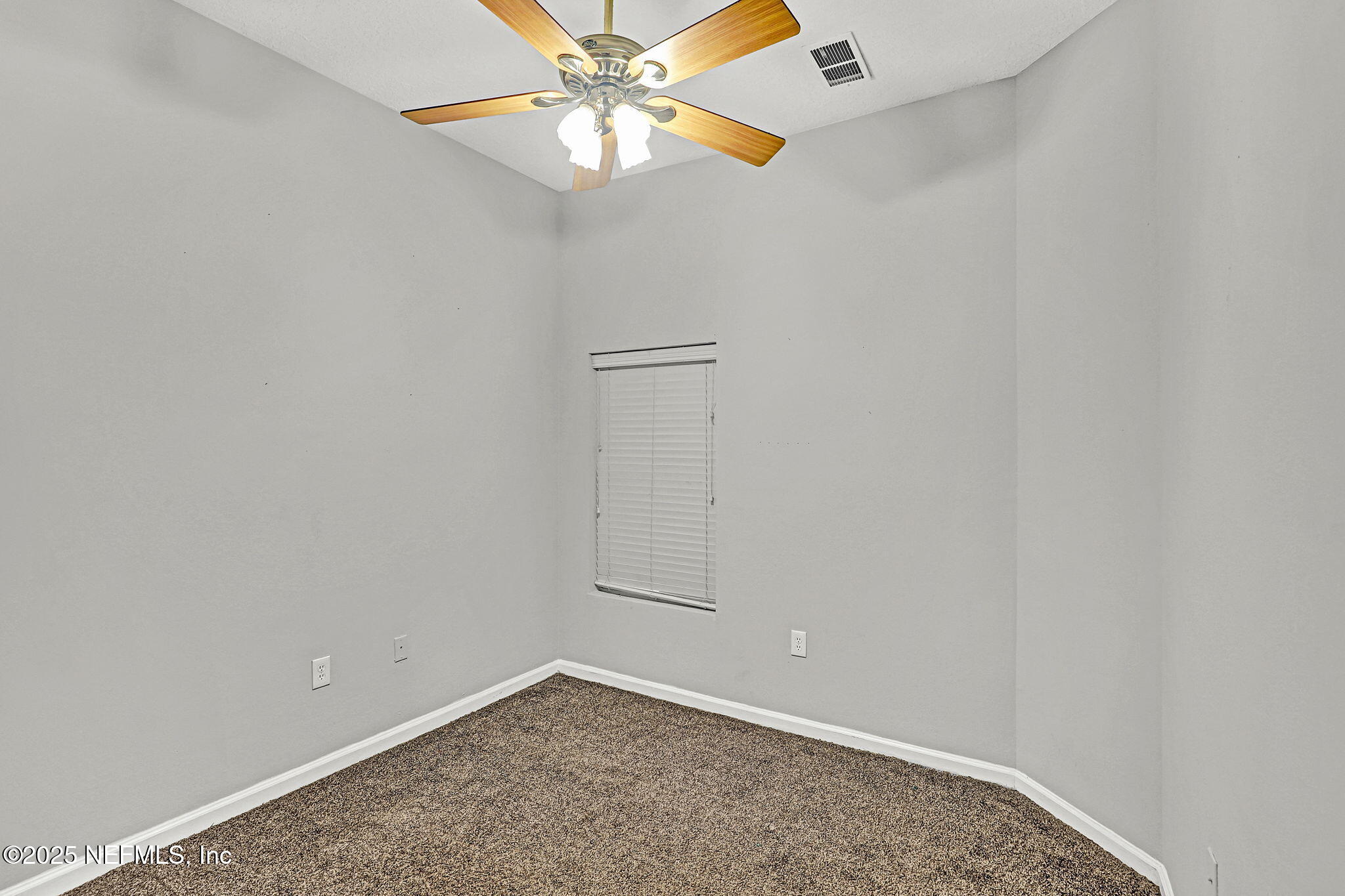 7920 Merrill Road, Unit 305 Jacksonville, FL 32277 - Photo 9 of 12 an empty room with windows and fan